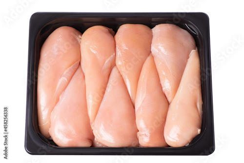 Raw chicken fillet in a packing tray. Lots of fresh skinless chicken fillets in a plastic tray in a supermarket. Raw chicken fillet.