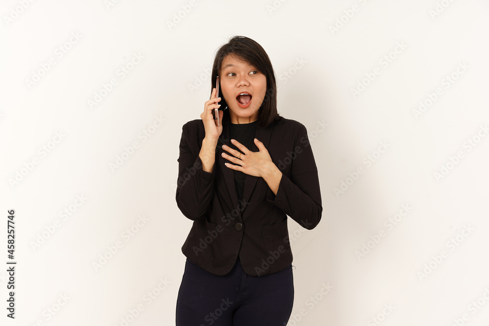 Beautiful Asian Woman Wearing black suit Talking on mobile phone with Shock facial expression Isolated on white background Beautiful Asian Woman Wearing black suit Talking on mobile phone with Shock facial expression Isolated on white background