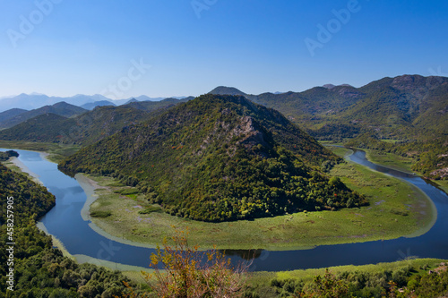 Breathtaking view of the Crnojevica river canyon from the Pavlova Strana Viewpoint, Lake Skadar, Montenegro. The place where the river bends in a horseshoe shape around a green mountain