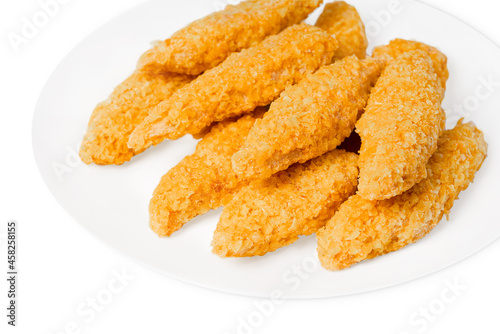 Fast pre cooked, homemade food.Fast food.Chicken breaded nuggets on a white plate.Raw chicken fillet inner, sprinkled with bright breading.