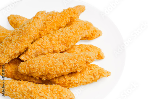 Raw chicken fillet inner, sprinkled with bright breading.
