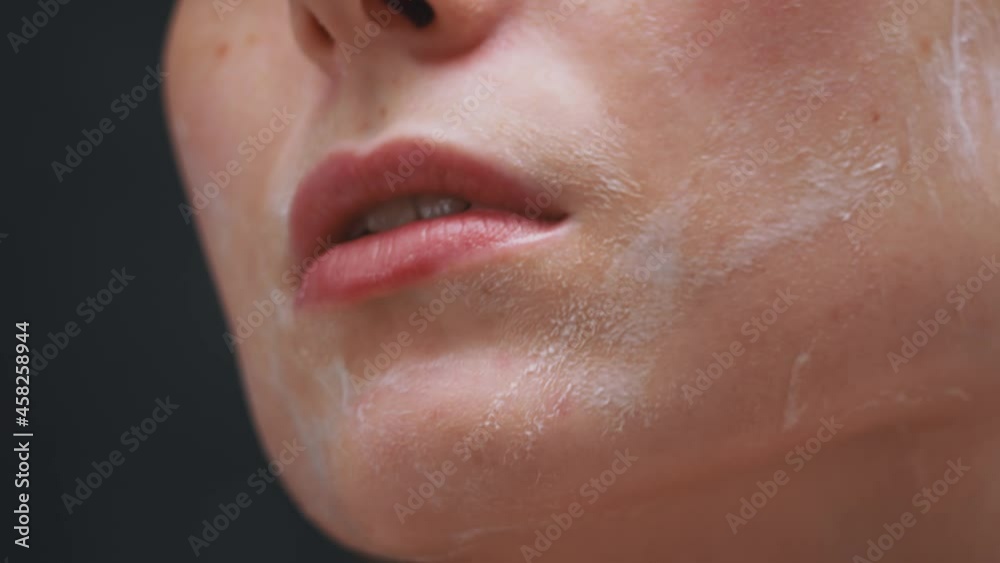 Closeup young woman applying face cream cleansing foamy soap cosmetic