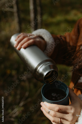 forest picker in the fall with thermos