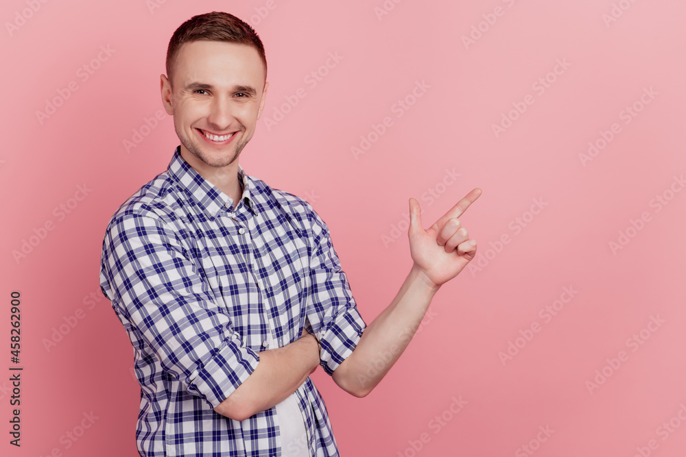 Profile side photo of young guy pointing forefinger empty space ad choice decision isolated on pink background Profile side photo of young guy pointing forefinger empty space ad choice decision isolated on pink background