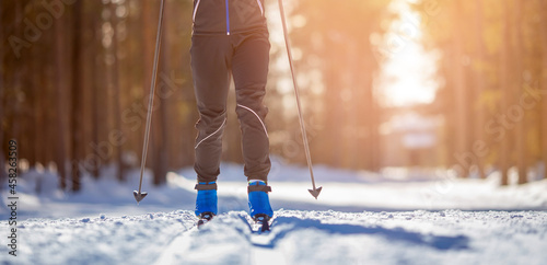 Foto Cross country skiing Banner, winter sport on snowy track, sunset background