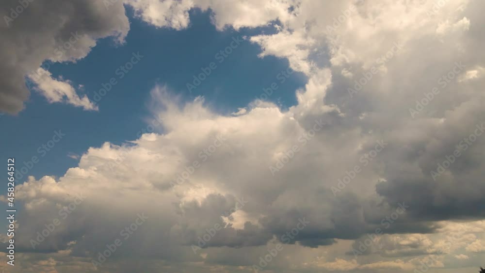 Panorama with moving clouds in sunlight against a blue sky. Time lapse, evening sky at sunset. Weather, cloudy nature background, time lapse. Video, footage for transition or intro. UHD 4K. Panorama with moving clouds in sunlight against a blue sky. Time lapse, evening sky at sunset. Weather, cloudy nature background, time lapse. Video, footage for transition or intro. UHD 4K.