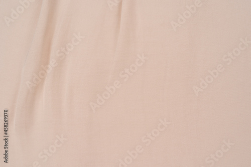 Smooth elegant golden silk or satin luxury cloth texture can use as wedding background
