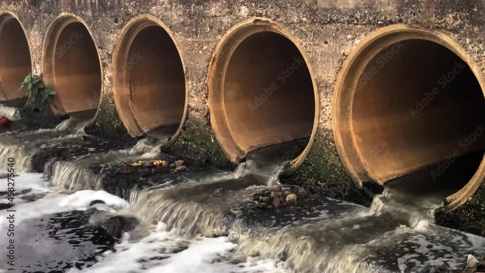 Sewage water flowing into river body and polluting the water and environment. Sewage water flowing into river body and polluting the water and environment.