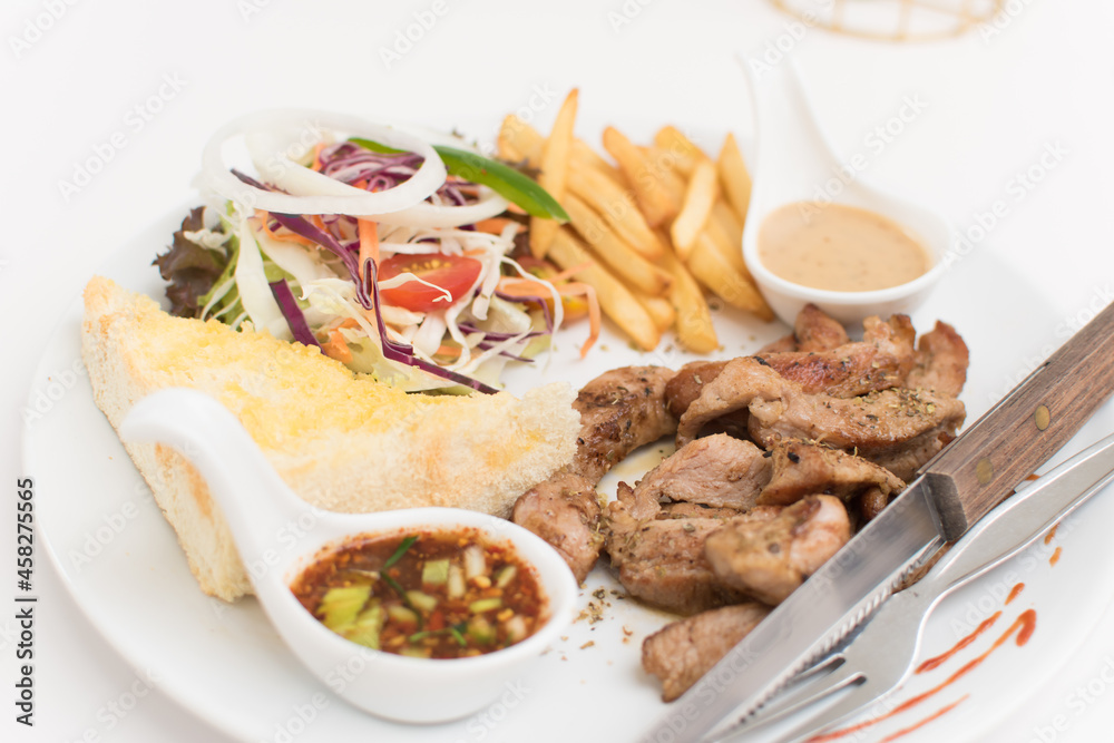 Steak platter with a side dish of bread, salad, sauce, french fries. Steak platter with a side dish of bread, salad, sauce, french fries.