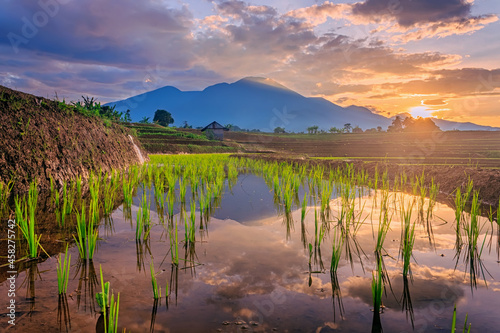 Landscape view beauty morning indonesia, morning atmosphere the sunrise shines brightly over the rice terraces, high mountains and sky reflections