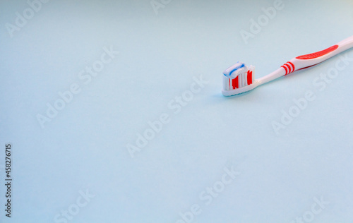 red toothbrush with blue Toothpaste