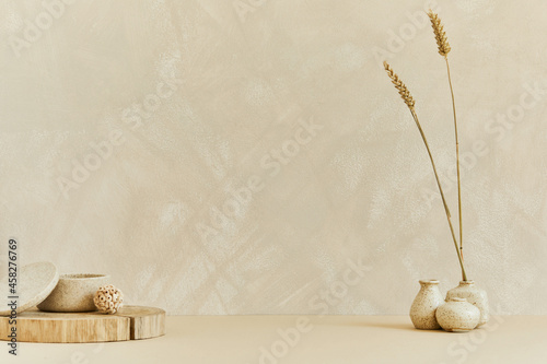 Minimalistic interior design with copy space, natural materials as wood and marbel, dry plants and personal accessories. Neutral beige colors, template. photo