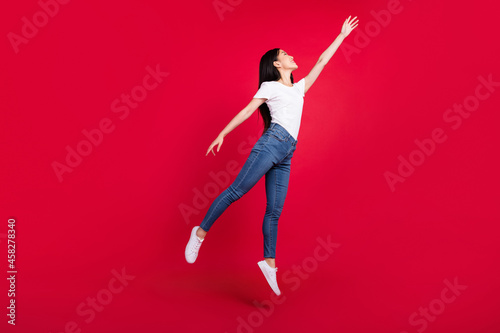 Full length photo of young korean girl happy positive smile catch umbrella isolated over red color background
