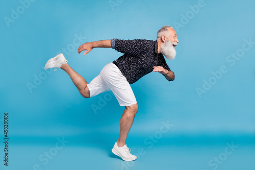 Full length body size sie profile photo man running fast hurrying isolated pastel blue color background