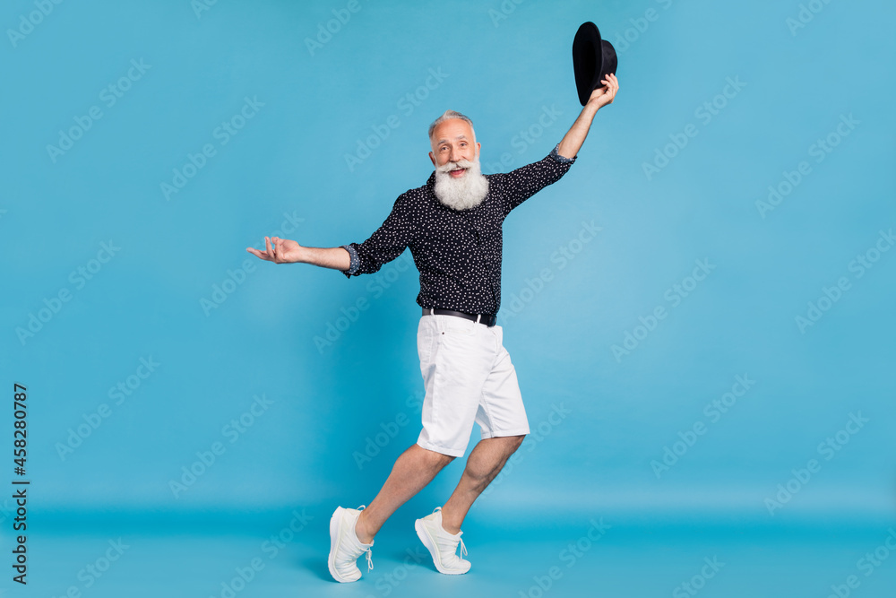 Full length body size sie profile photo man dancing with black hat isolated pastel blue color background