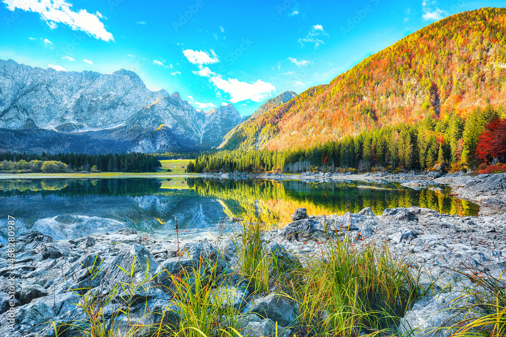 Fototapeta premium Fairytale view of Fusine lake with Mangart peak on background