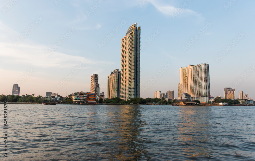 View of tall buildings and towns along the river, with sky background.