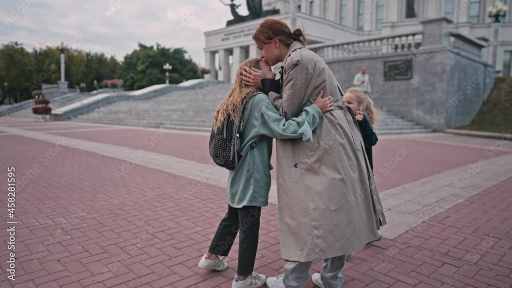 mom escorts her little daughters to school. happy family kid dream school concept. schoolgirl hurrying class for lesson to school. kid and mom lifestyle goodbye before school. High quality 4k footage mom escorts her little daughters to school. happy family kid dream school concept. schoolgirl hurrying class for lesson to school. kid and mom lifestyle goodbye before school. High quality 4k footage