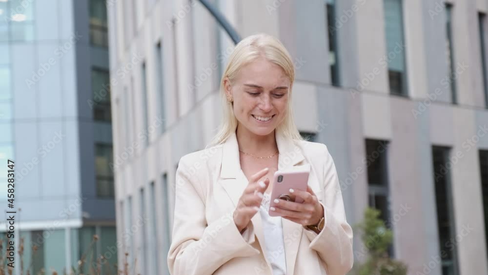young businesswoman using smartphone in financial district - corporate lifestyle concept young businesswoman using smartphone in financial district - corporate lifestyle concept