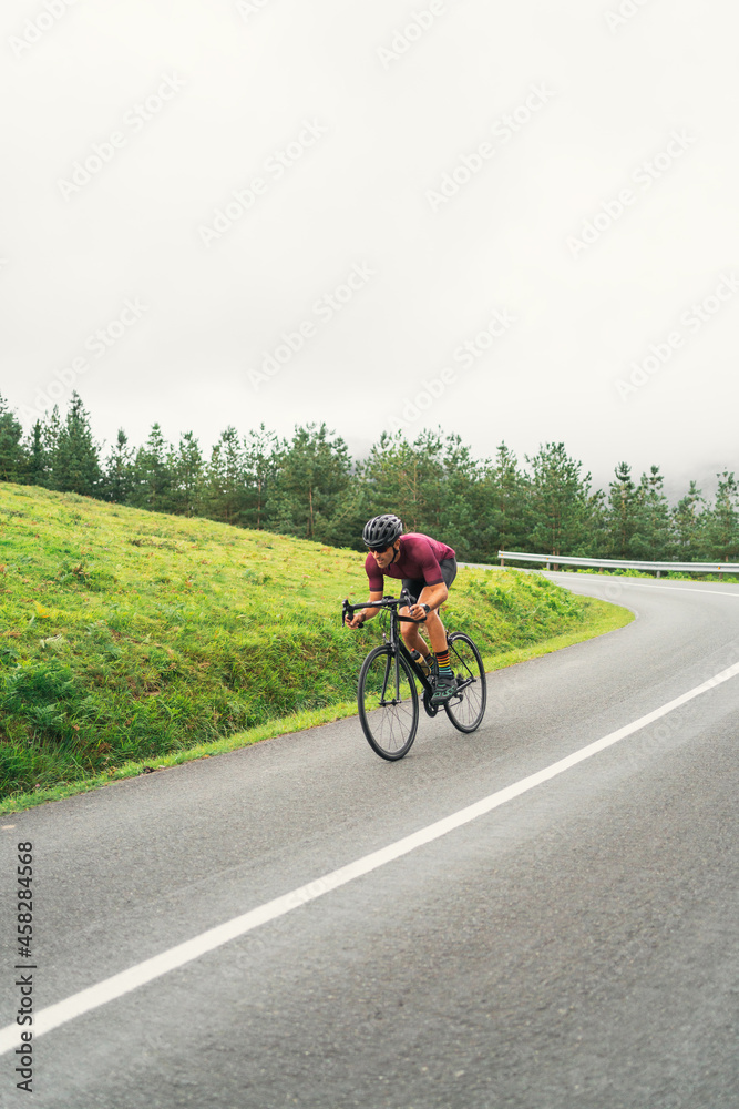 Bicyclist riding bike during training on countryside road Bicyclist riding bike during training on countryside road