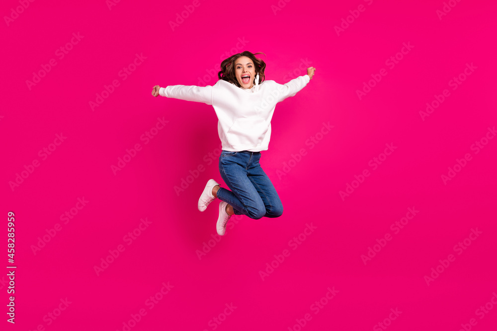 Full body photo of young excited girl happy positive smile jump up active isolated over pink color background