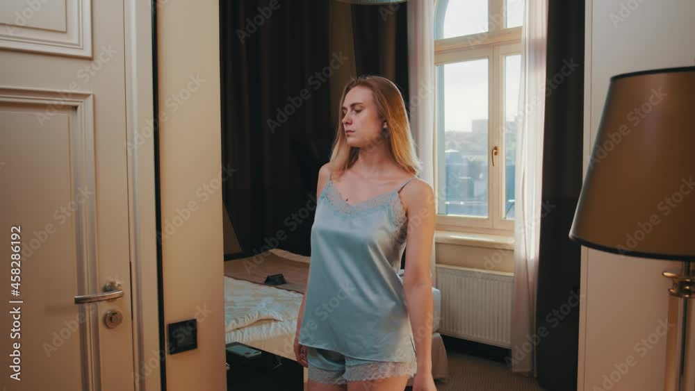 Elegant woman waking up in the morning in luxurious cozy apartment. Attractive girl wearing lingerie walking to the bathroom. Home lifestyle. Beauty females. Elegant woman waking up in the morning in luxurious cozy apartment. Attractive girl wearing lingerie walking to the bathroom. Home lifestyle. Beauty females.