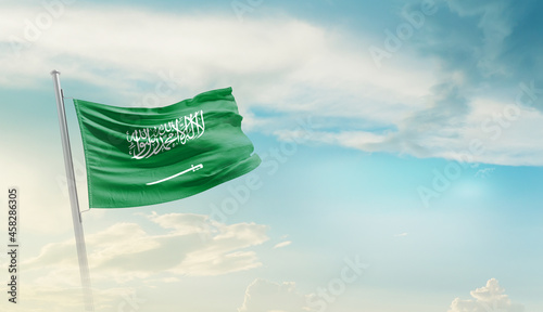 Saudi Arabia national flag cloth fabric waving on the sky - Image photo