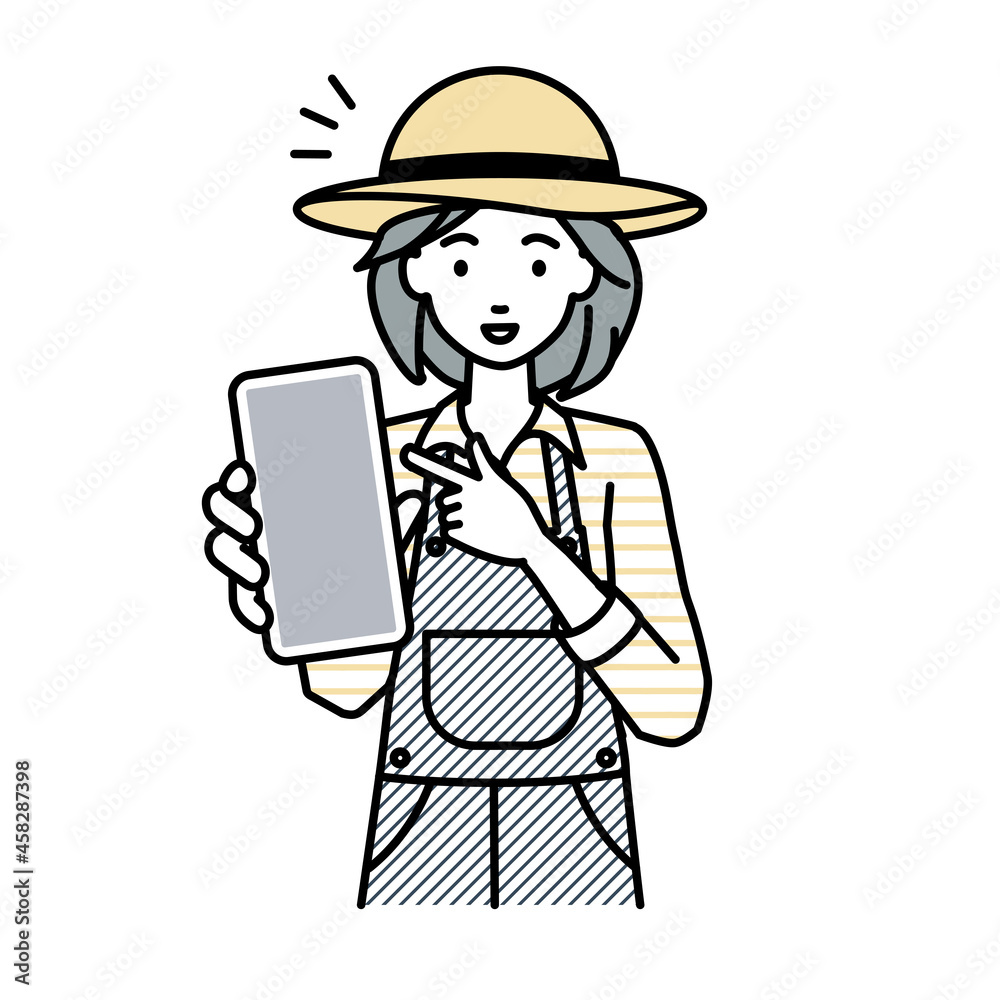 立ってスマートフォンを指差してこちらに向けて見せている農家の女性