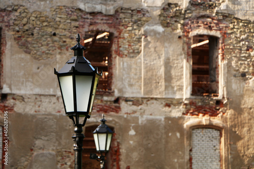 Old lantern on the background of the ancient wall.