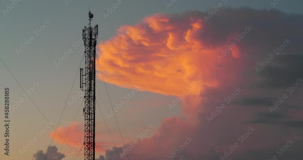 Cell tower and big orange sunset clouds. Cinema 4K 60fps video