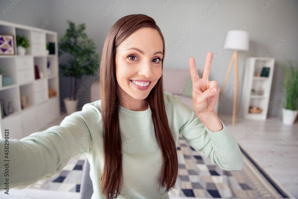 Self-portrait of attractive cheerful woman staying safe showing v-sign good mood free time at home indoors Self-portrait of attractive cheerful woman staying safe showing v-sign good mood free time at home indoors