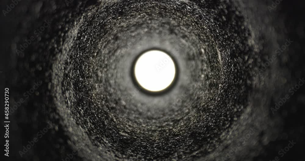 Moving forward in dark tunnel towards light at the end