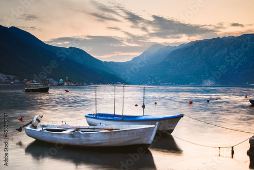 Boats sitting at sunset on Kotor Bay at Perast Montenegro in the late summer.