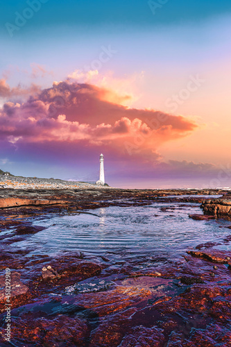 Scenic lighthouse landscape and sunset view along world famous coastline. Cape Town, South Africa is a wonderful travel destination for nature, adventure and tourism. photo