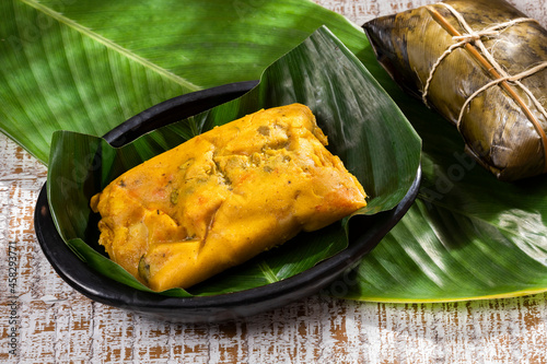 Tamale Typical Colombian Food Wrapped In Banana Leaves photo