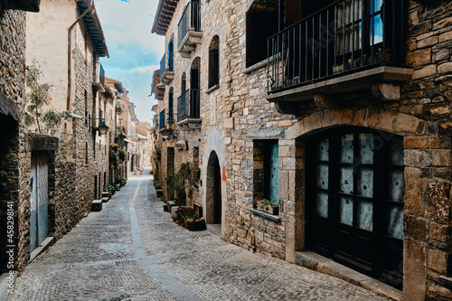 Strolling through the narrow cobbled street at Ainsa village, Aragon, Spain