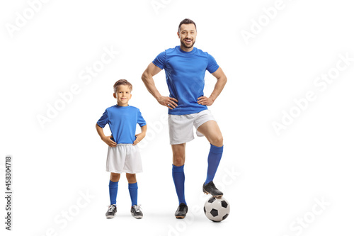 Young man and a boy with a soccer ball wearing blue sport jersey © Ljupco Smokovski