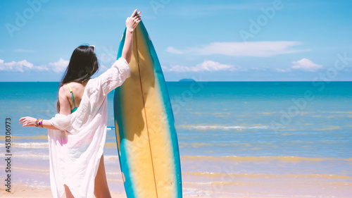 sexy lady in holiday. Surfer girl on the beach holding surf board watching ocean in sunny day. True happy emotions of young active pretty woman prepare to surfing. Summer vacation lifestyle. outdoor.