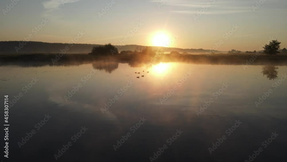 Sunrise over the river and the town of Suprasl.View from the drone over the river ,the lagoon,the surrounding fields,meadows and forests. Sunrise over the river and the town of Suprasl.View from the drone over the river ,the lagoon,the surrounding fields,meadows and forests.