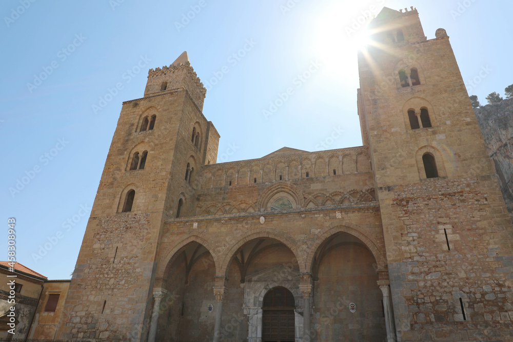 Cefalu cathedral against blue sunny sky, Sicily, Italy