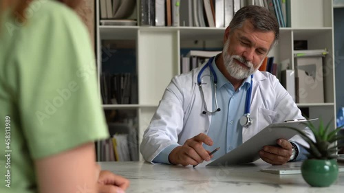 Smiling male professional doctor handshakes female patient agree on surgery, medical service trust concept