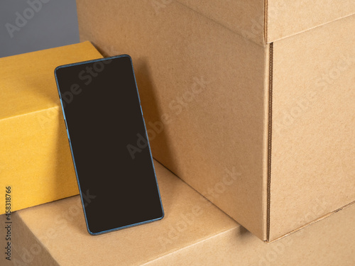 Phone on cardboard box. Box...