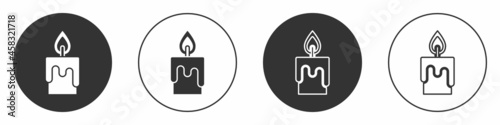 Black Burning candle icon isolated on white background. Cylindrical candle stick with burning flame. Circle button. Vector