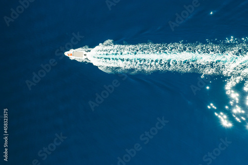 Top view of the boat or white yacht sails on the blue water of the Adriatic sea © vladim_ka