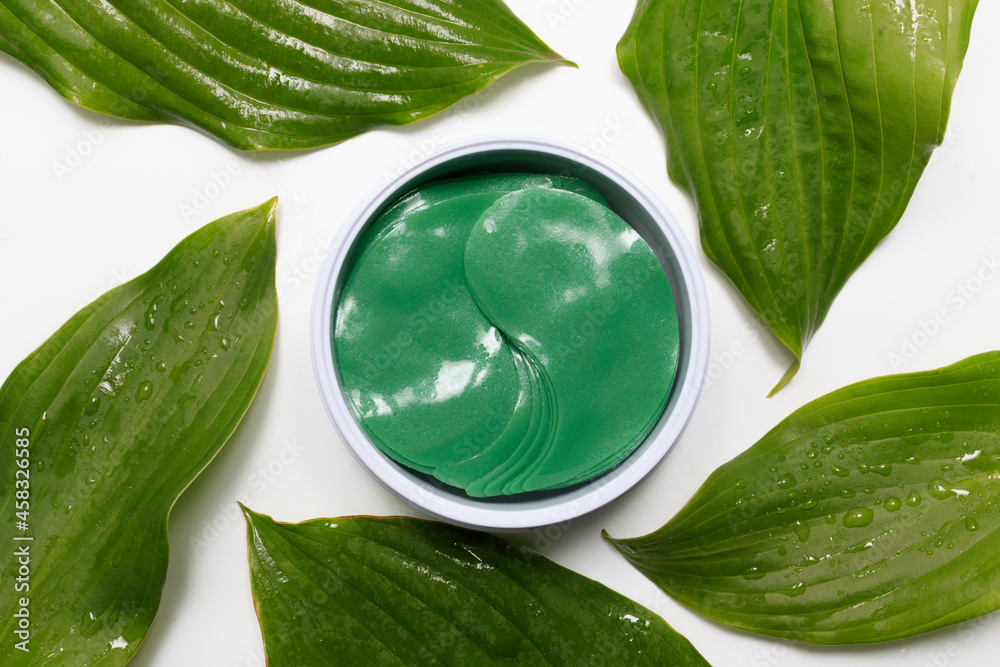 Obraz premium under eye patches. cosmetics collagen hydrogel patch among green leaves. Lifting anti-wrinkle mask under eyes. Skincare concept.