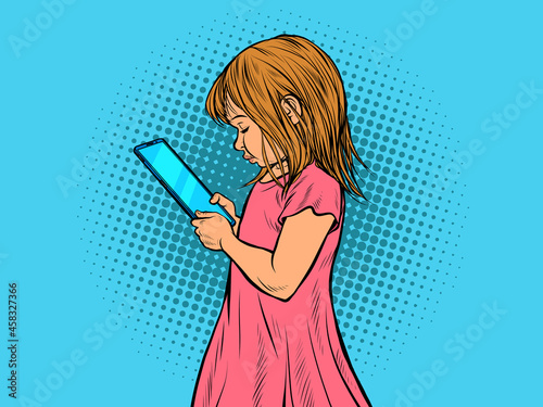 a little girl uses a smartphone. Electronic gadgets and children
