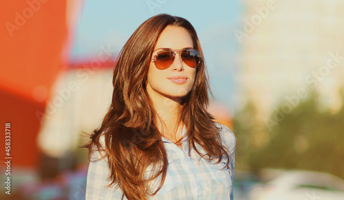 Summer portrait of beautiful young brunette woman in the city