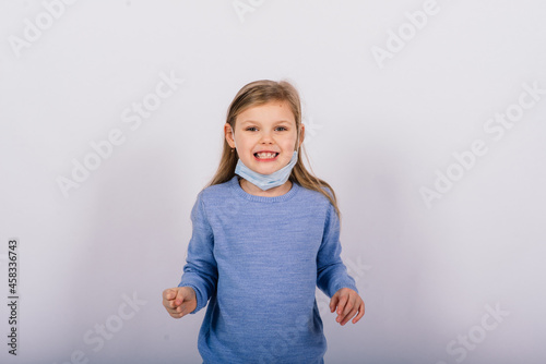 Little cute kid in a studio, wearing mask for protection, Coronavirus outbreak concept.