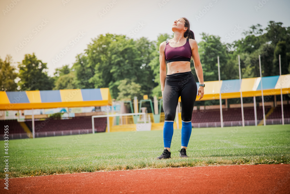 Young athletic woman stretches and prepares to run. strong sport woman