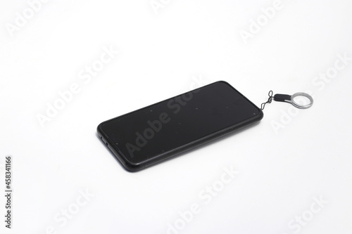 Black phone with black screen  tempered glass  and key chain  isolated on white background